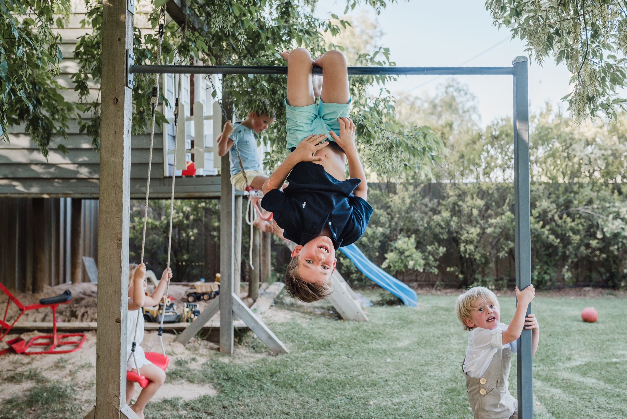 Children climbing, swinging and playing together outdoors